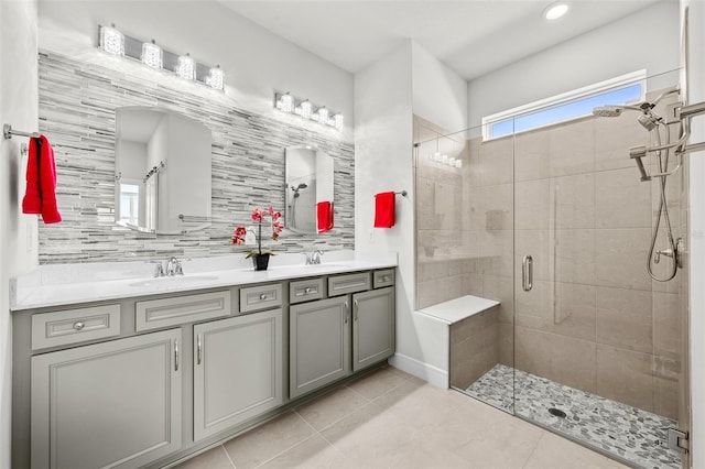 bathroom featuring an enclosed shower, vanity, and backsplash