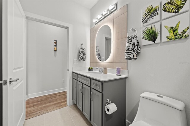 bathroom featuring toilet, vanity, and tile patterned flooring