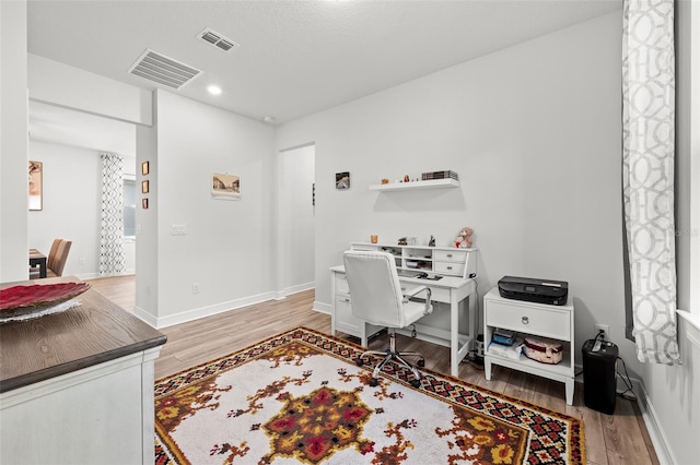 office with wood-type flooring