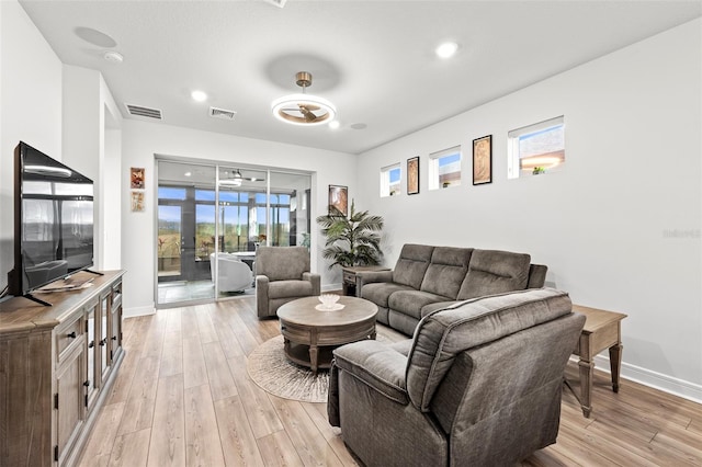 living room with french doors and light hardwood / wood-style flooring