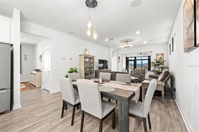 dining space featuring ceiling fan and light hardwood / wood-style floors