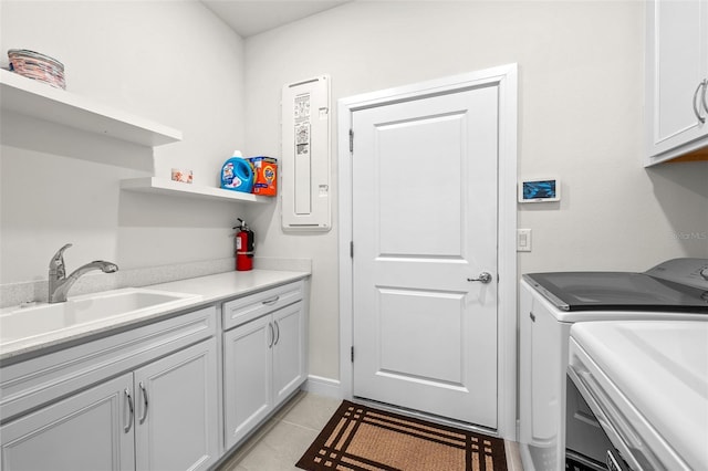 washroom with cabinets, sink, light tile patterned floors, and independent washer and dryer