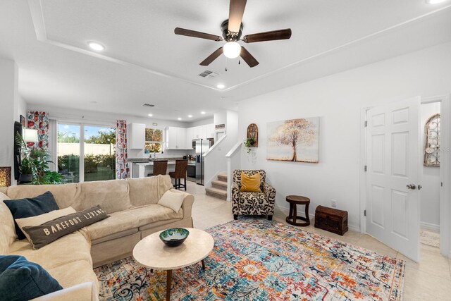 living room with ceiling fan and light tile patterned floors