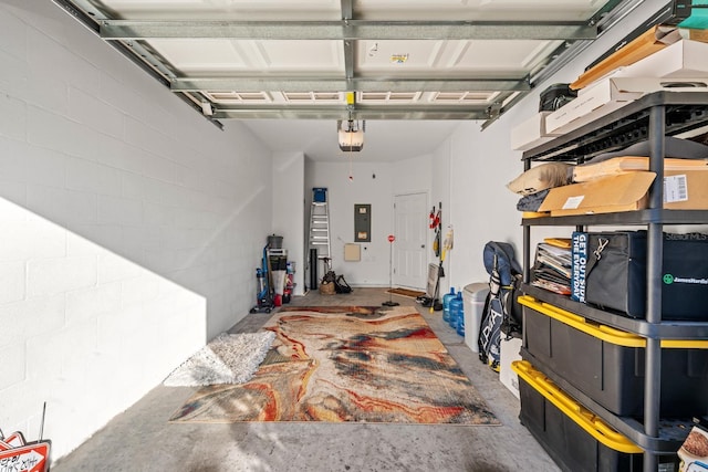 garage with a garage door opener and electric panel