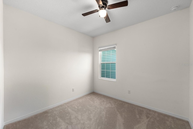 carpeted empty room featuring ceiling fan