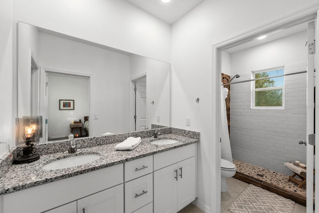 bathroom featuring tile patterned floors, curtained shower, vanity, and toilet