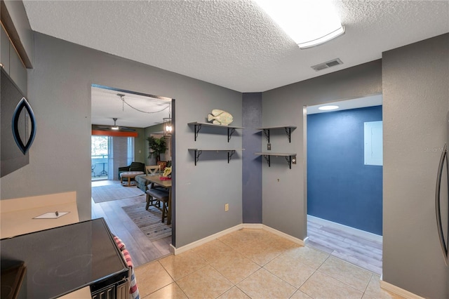 interior space featuring a textured ceiling and ceiling fan