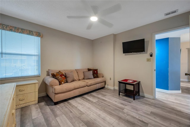 living room with ceiling fan and light hardwood / wood-style floors