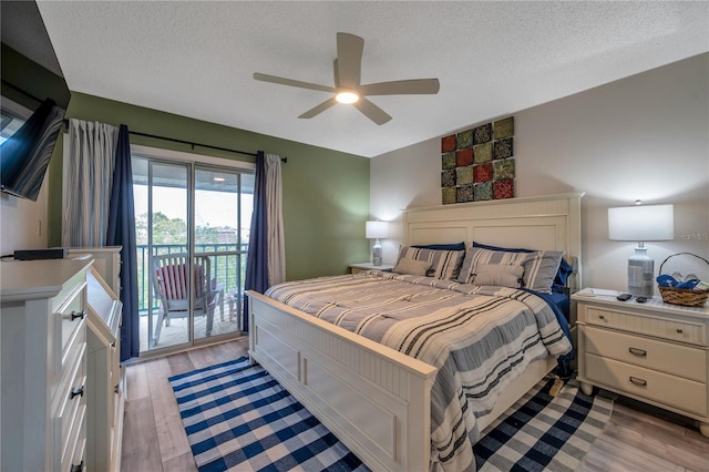 bedroom featuring a textured ceiling, light wood-type flooring, access to outside, and ceiling fan