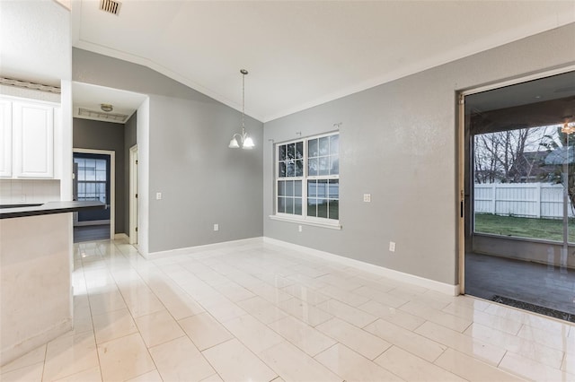 unfurnished dining area with a wealth of natural light, a chandelier, lofted ceiling, and ornamental molding