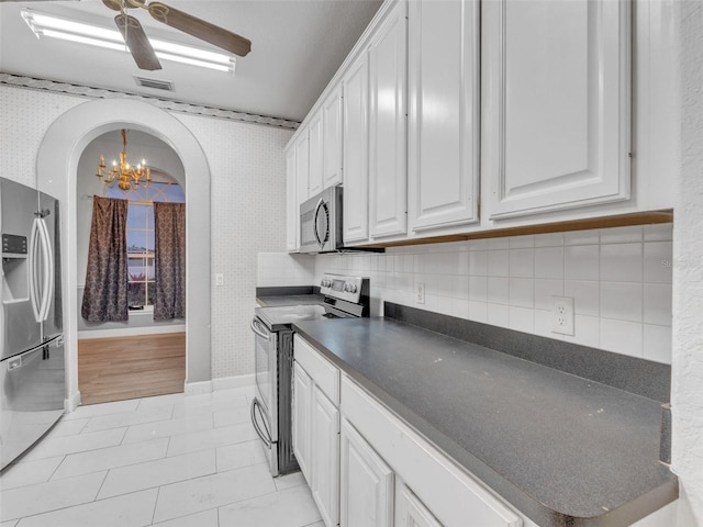 kitchen featuring light tile patterned floors, stainless steel appliances, white cabinetry, and tasteful backsplash