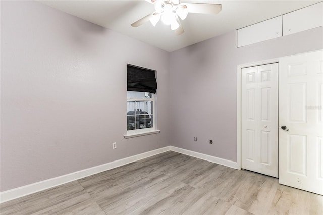 unfurnished bedroom with ceiling fan, a closet, and light wood-type flooring