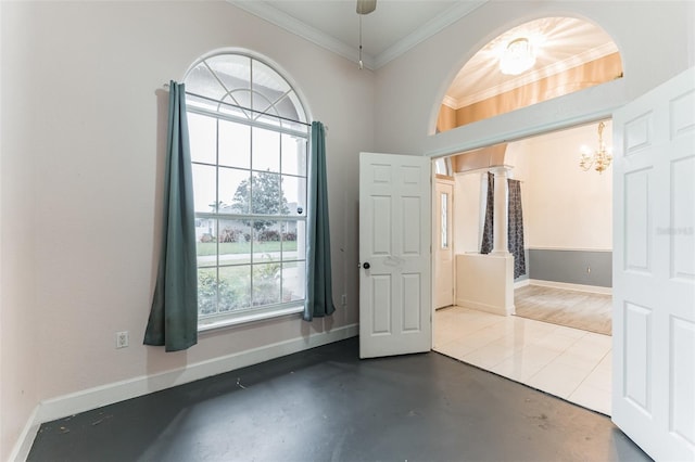 foyer featuring concrete floors, an inviting chandelier, and ornamental molding