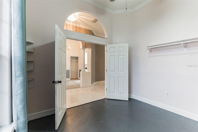 interior space with concrete flooring and ornamental molding