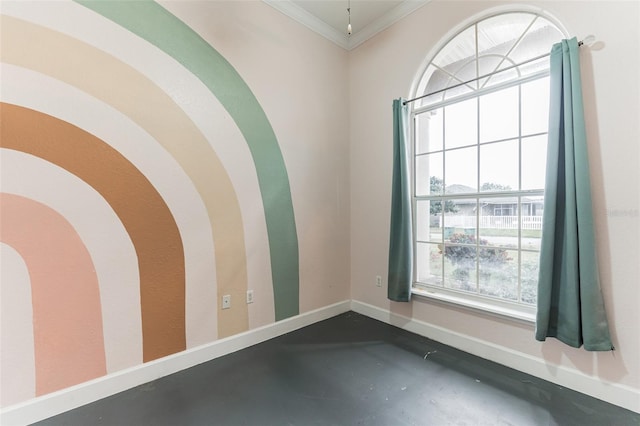 empty room featuring crown molding and a wealth of natural light