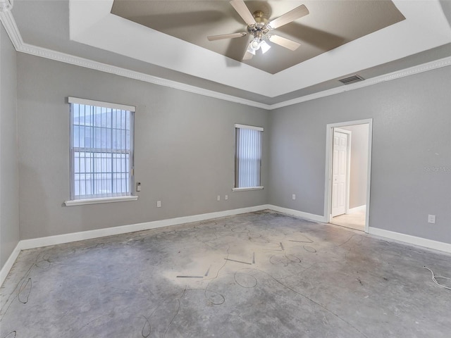 spare room with ceiling fan, a raised ceiling, and ornamental molding