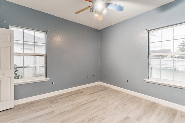 empty room featuring ceiling fan and light wood-type flooring