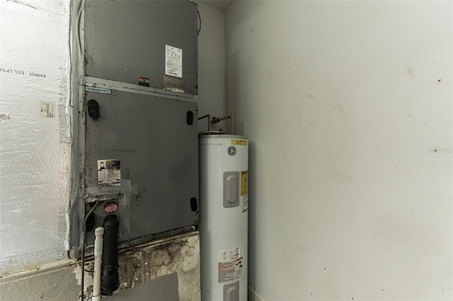 utility room featuring electric water heater and heating unit