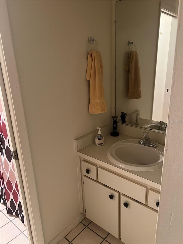 bathroom featuring toilet, tile patterned floors, and vanity