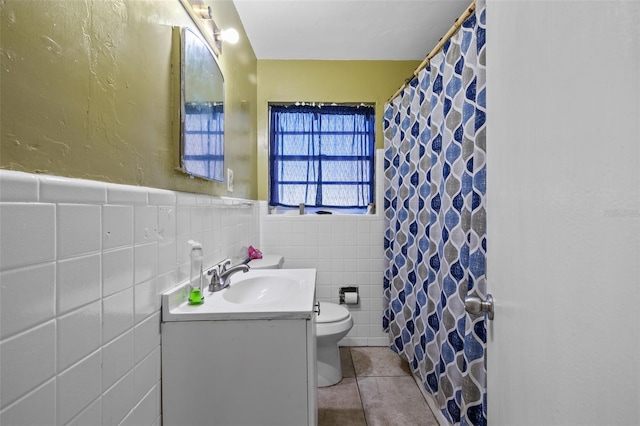 bathroom featuring vanity, tile patterned floors, a shower with shower curtain, toilet, and tile walls