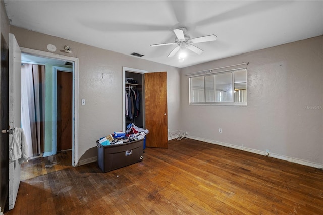 bedroom with hardwood / wood-style floors, a closet, and ceiling fan