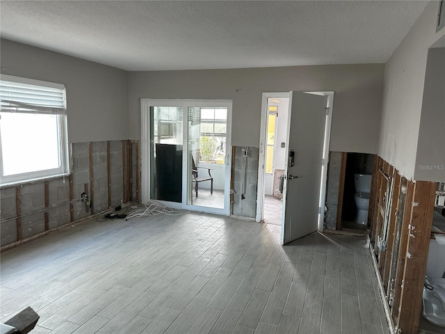 spare room with wood-type flooring and a textured ceiling