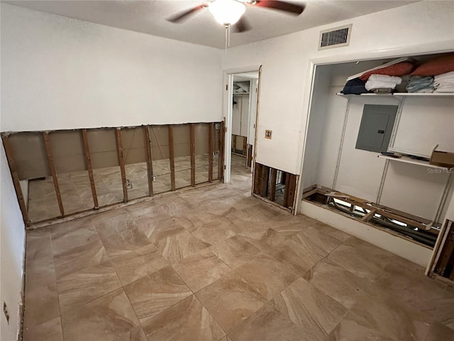 interior space with electric panel and ceiling fan