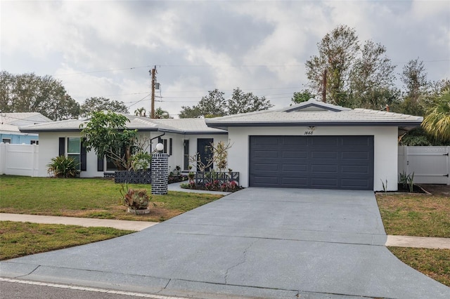 single story home featuring a front yard and a garage