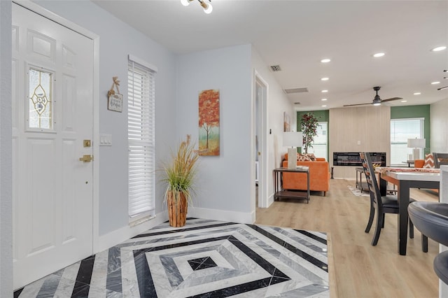 foyer entrance featuring ceiling fan and light hardwood / wood-style floors