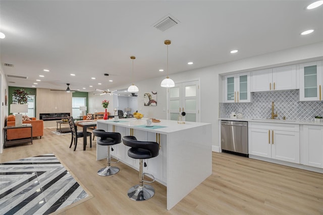 kitchen with white cabinetry, ceiling fan, pendant lighting, and dishwasher