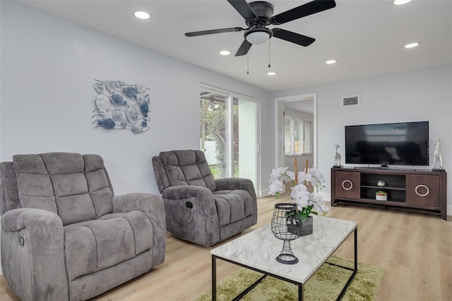 living room featuring ceiling fan and light wood-type flooring