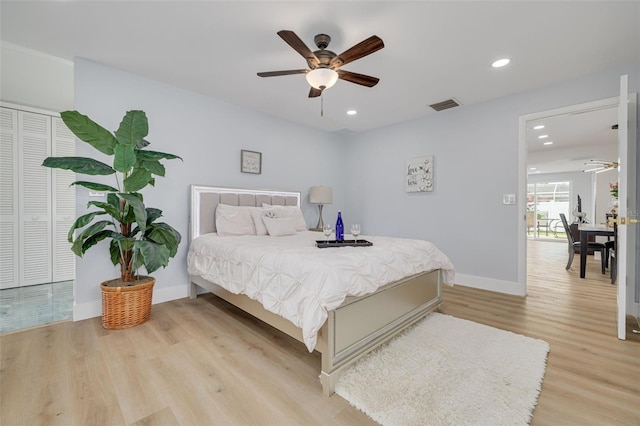 bedroom featuring light wood-type flooring, ceiling fan, and a closet