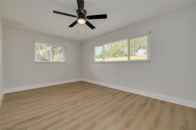 spare room with ceiling fan and light wood-type flooring