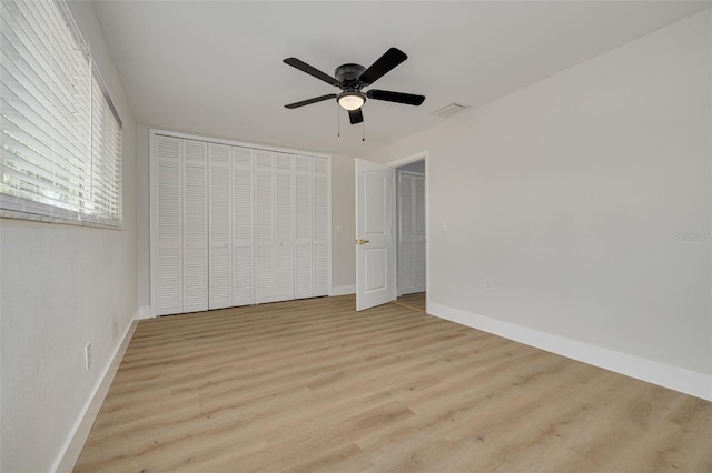 unfurnished bedroom with ceiling fan and light wood-type flooring