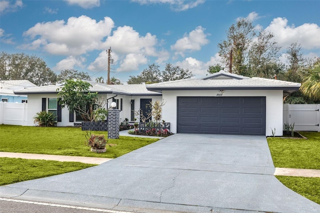 ranch-style house with a garage and a front lawn