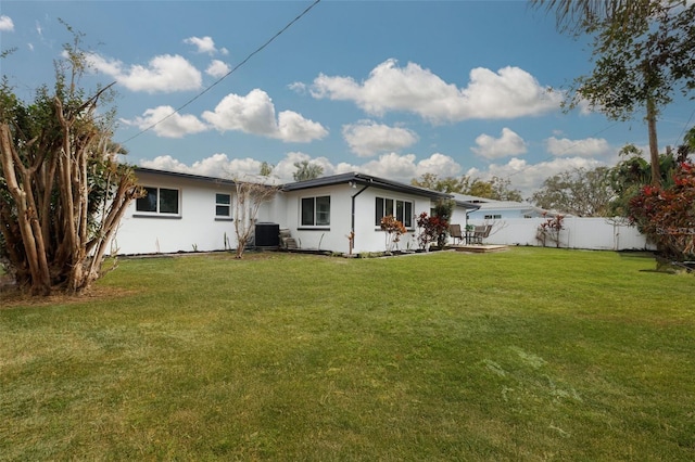 rear view of house with a yard and central air condition unit