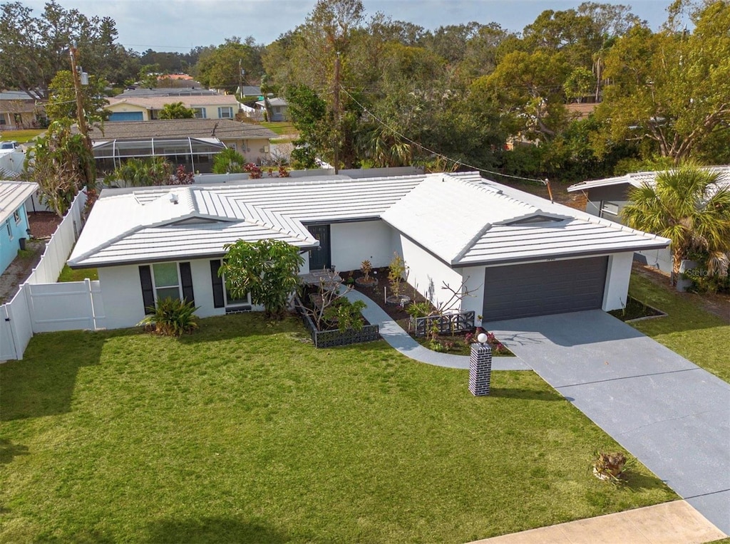 view of front of property featuring a garage and a front yard