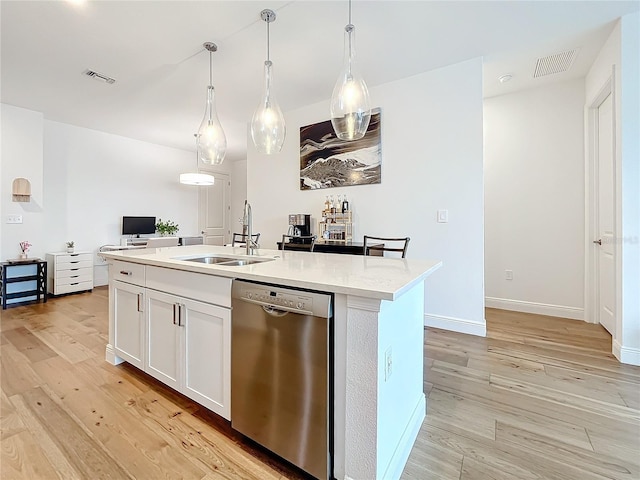 kitchen featuring a kitchen island with sink, sink, dishwasher, white cabinetry, and hanging light fixtures