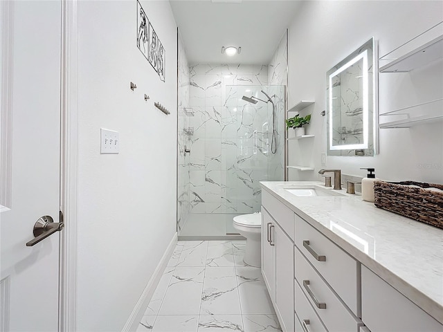 bathroom with a tile shower, vanity, and toilet