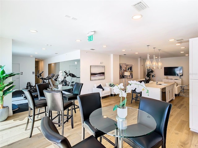 dining room featuring light hardwood / wood-style floors and sink