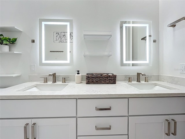 bathroom featuring a sink and double vanity