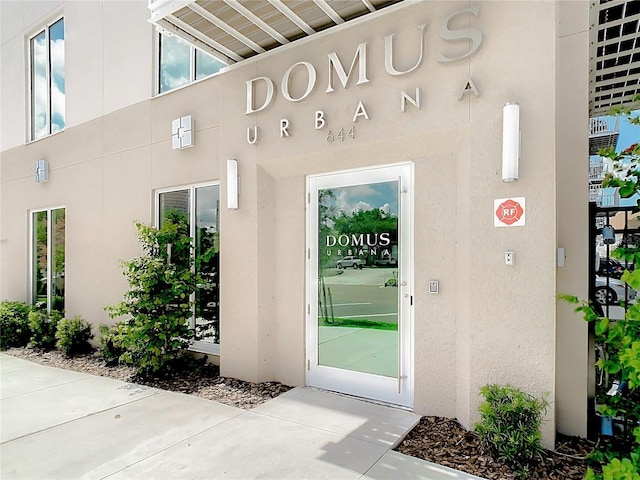 property entrance with stucco siding