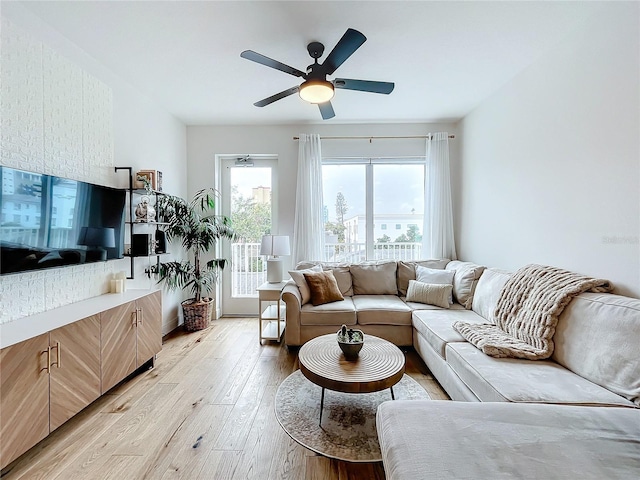 living room with light wood finished floors and ceiling fan