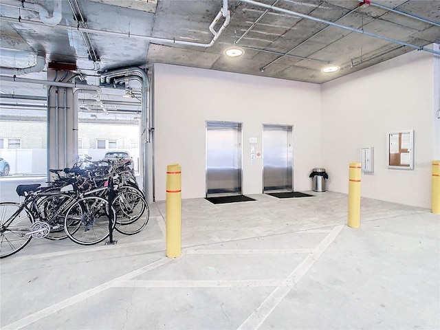 garage featuring elevator and bike storage