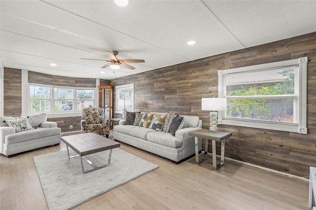 living room featuring ceiling fan and light wood-type flooring