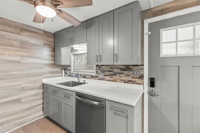 kitchen with dishwasher, sink, ceiling fan, gray cabinets, and light wood-type flooring