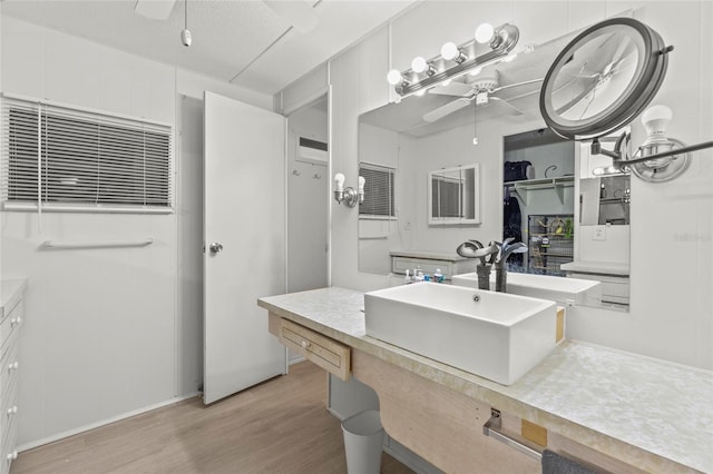 bathroom with ceiling fan, vanity, wood-type flooring, and a textured ceiling