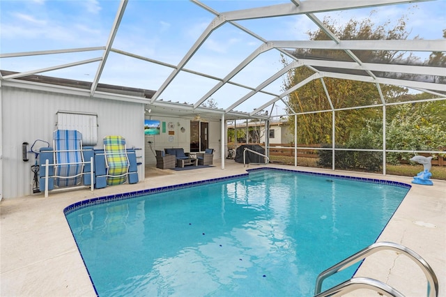 view of pool featuring a lanai, a patio area, and an outdoor living space