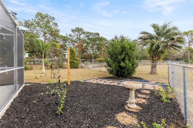 view of yard with glass enclosure