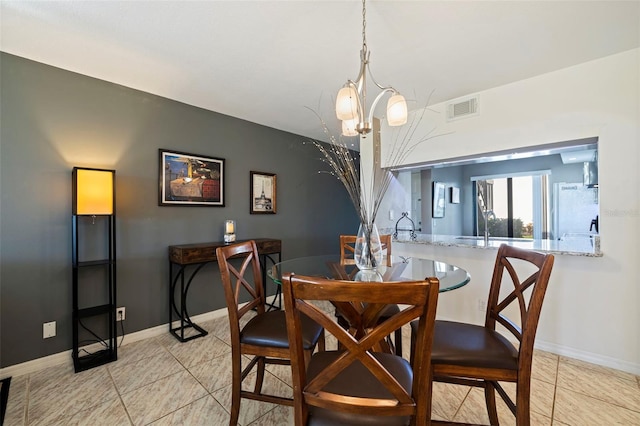 dining space with a chandelier